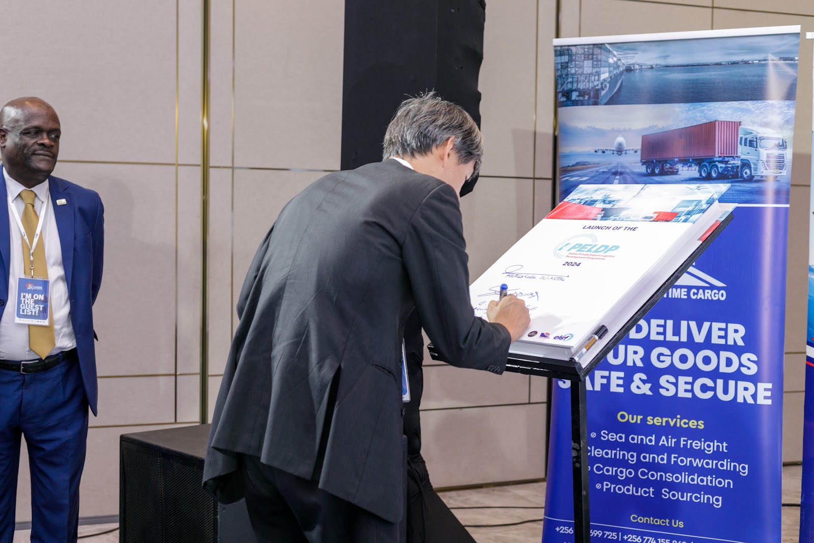 A delegate signing the PPELD partnership commitment